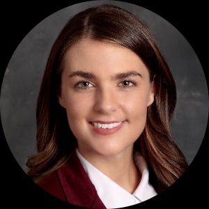 Alexandria Carrico, a white woman in a red blazer.