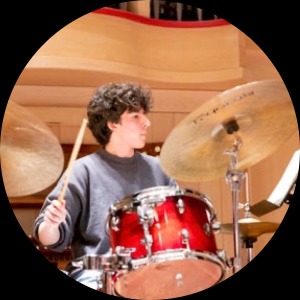 Allwyn Edwards, a white man playing drums.